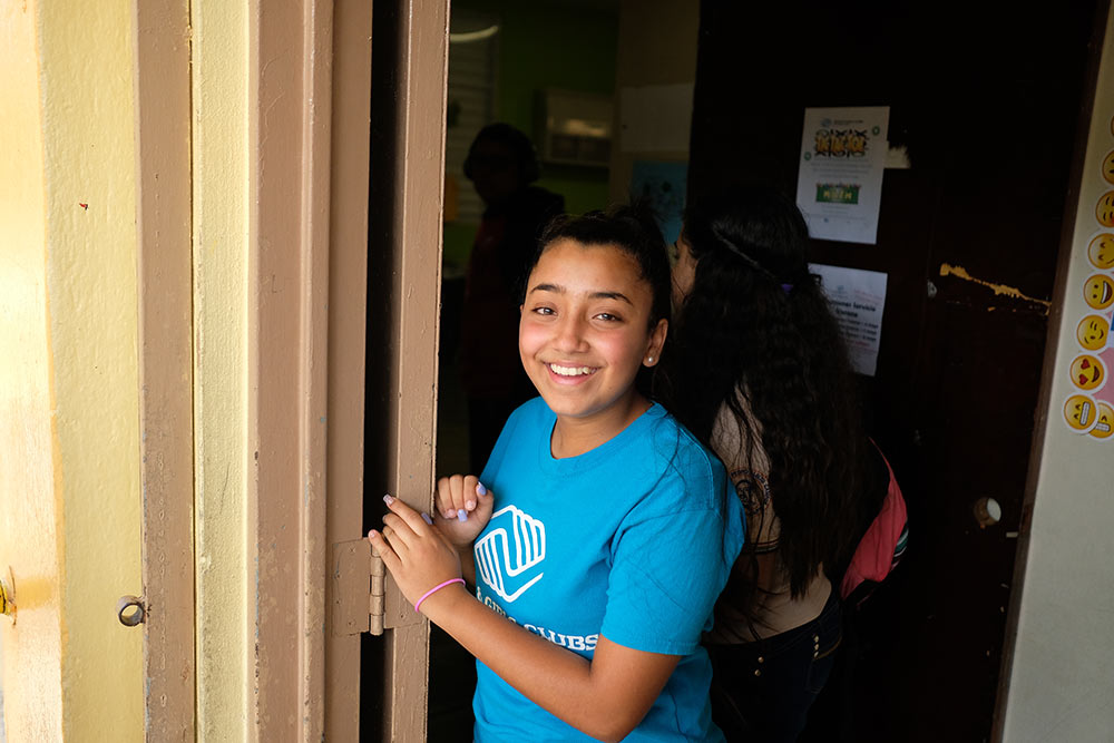 Gabriela stands at the entrance to the Boys & Girls Club in Puerto Rico.